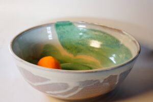 Pottery bowl with white and green glaze